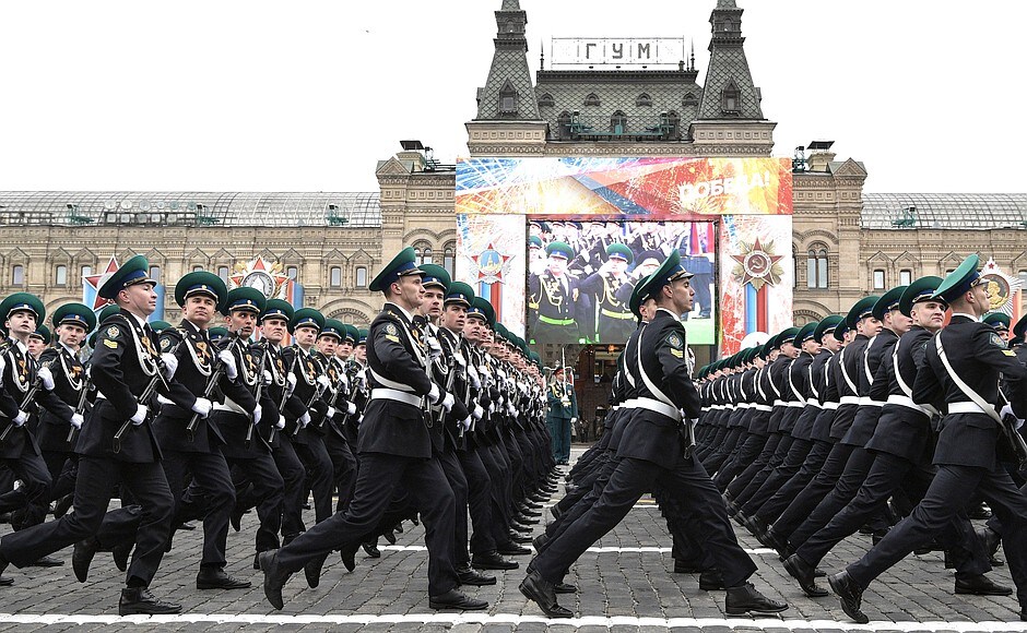 Description: The military parade passes iconic GUM department store